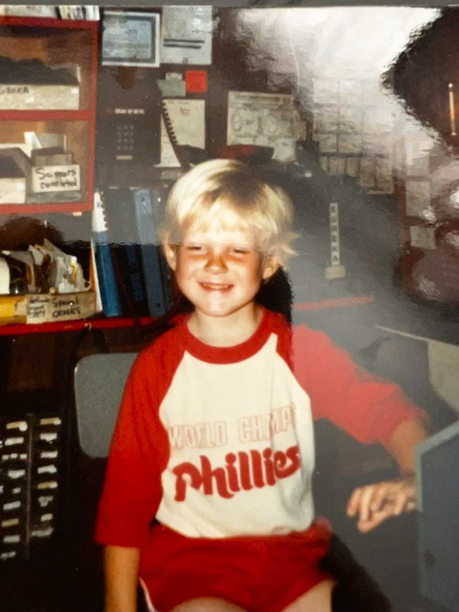 Mike as a kid wearing a Phillies shirt